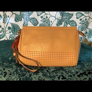 Tan Coach wristlet with red tassel